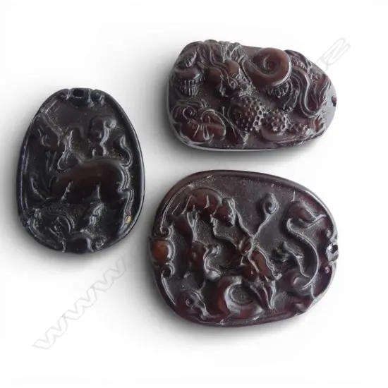 THREE CHINESE CARVED STONE PENDANTS