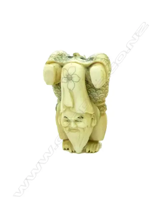 A Japanese carved ivory netsuke on Fukurokuju performing a handstand Image 1++