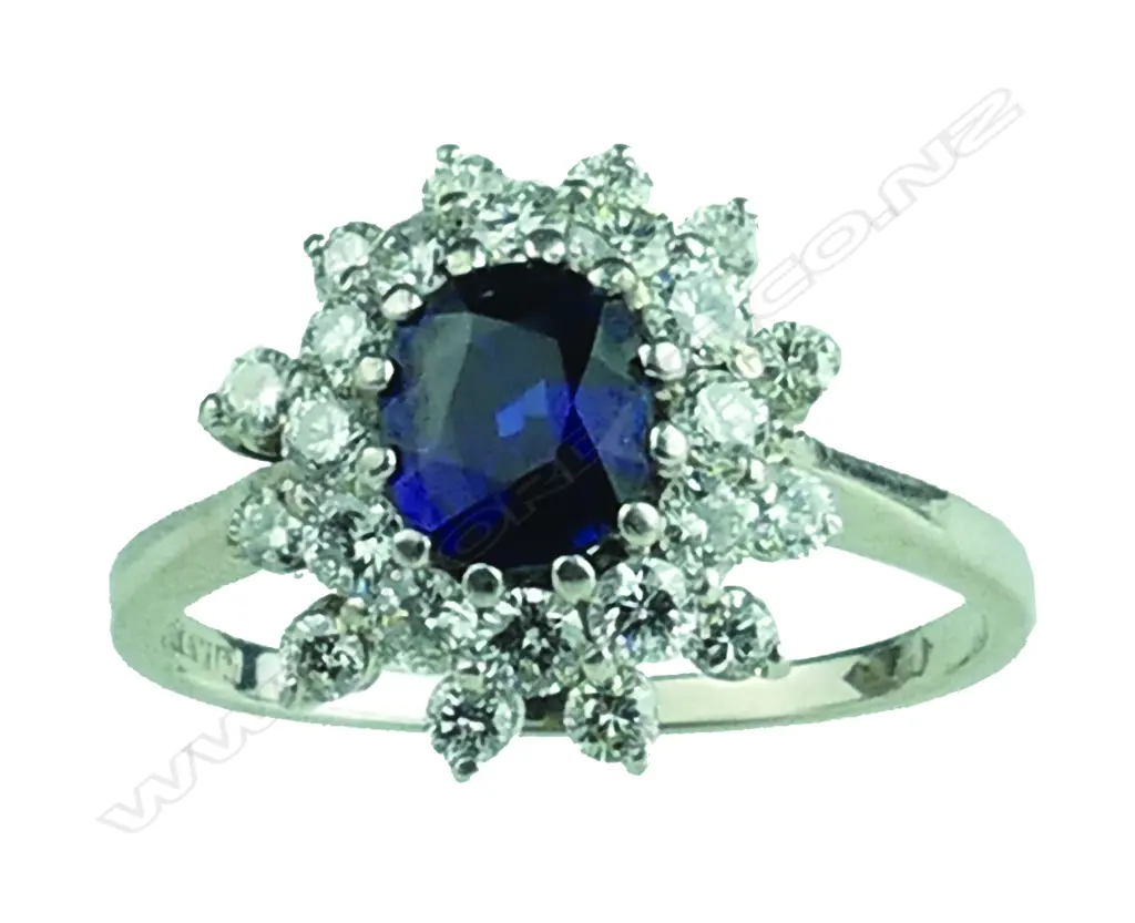 An 18ct. white gold sapphire and diamond cluster ring Image 1++