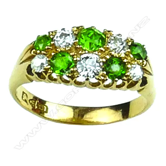 A lady's estate 18ct. yellow gold green garnet and diamond cluster ring