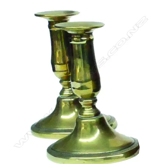A pair of Georgian brass short column candlesticks