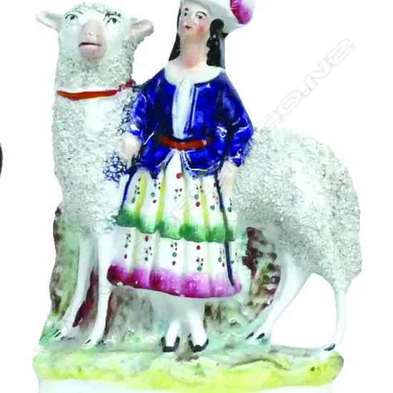 A Victorian Staffordshire figure group of a Scottish woman with sheep