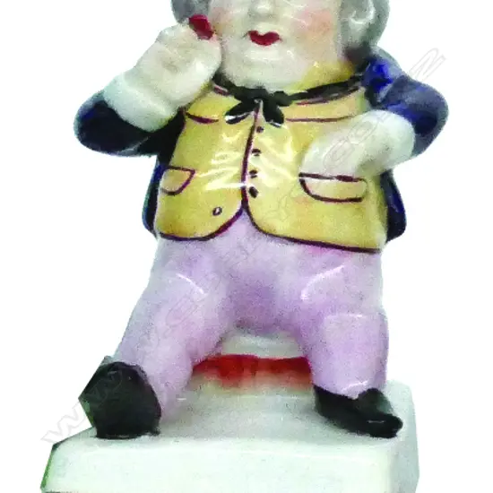 A 19thC Staffordshire figure of a snuff taker