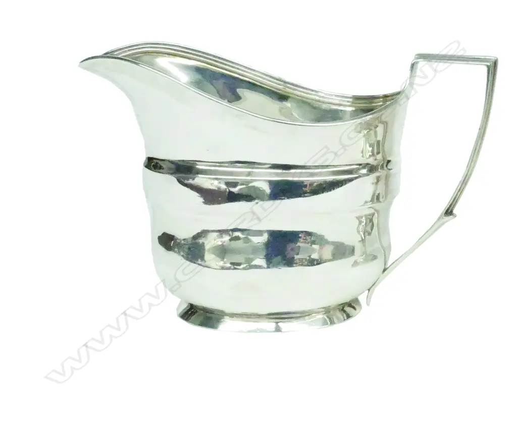 A George III silver flat bottom cream jug Image 1++