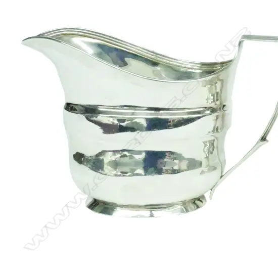 A George III silver flat bottom cream jug