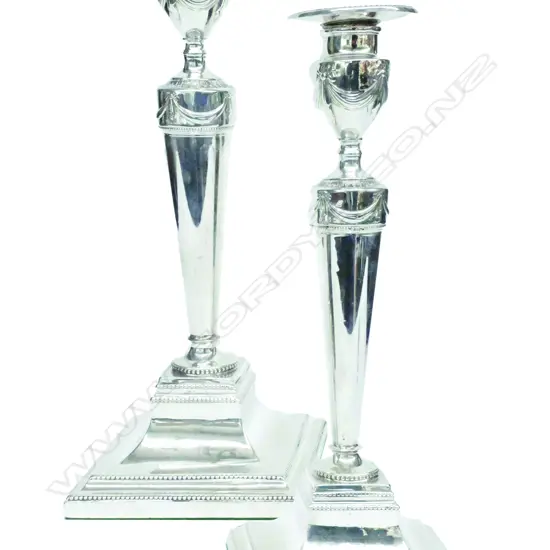 A pair of Geo. III silver candlesticks in the Adams' manner
