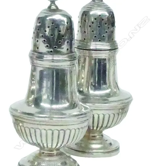 A pair of Victorian silver pepperettes