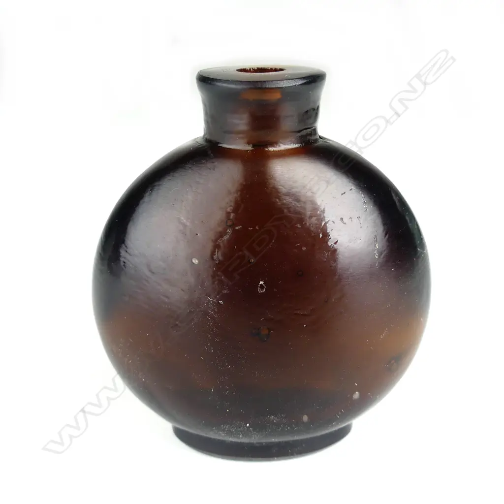A Chinese dark amber coloured glass snuff bottle Image 1++
