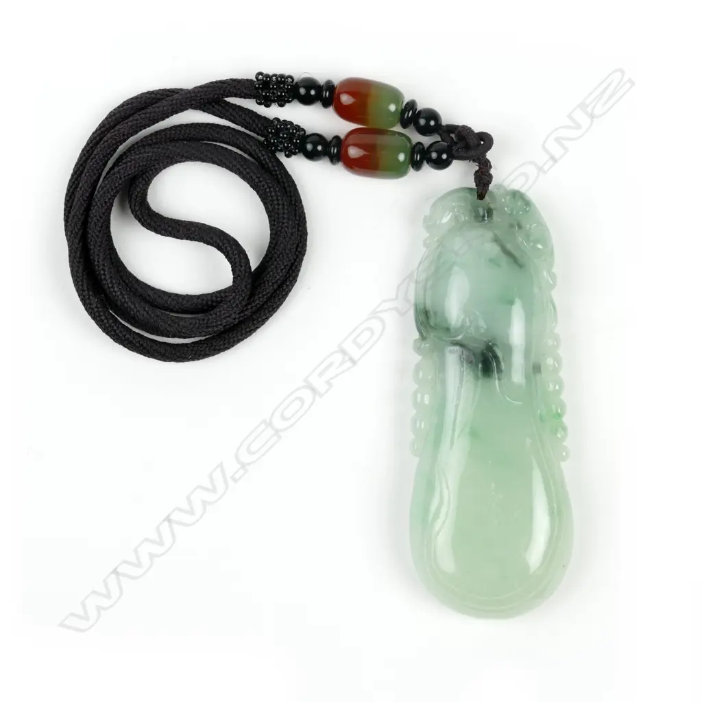 A Chinese green jade aubergine pendant on a beaded cord Image 1++