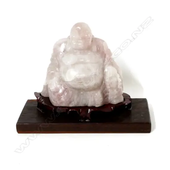 A pink quartz carved Buddha in glazed and mirrored case
