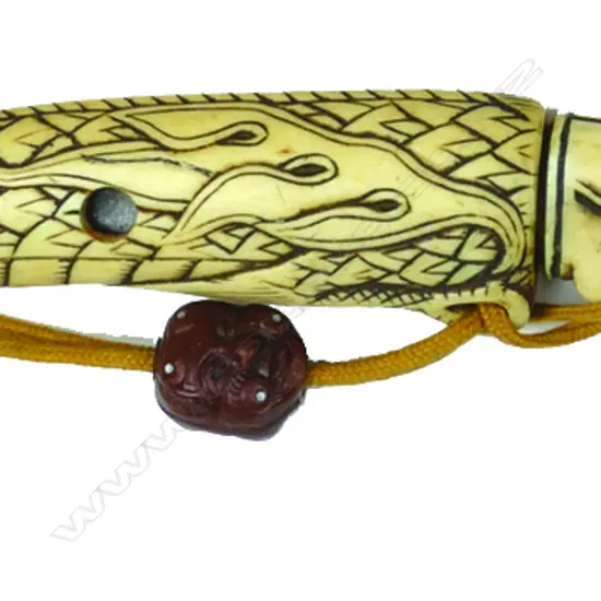 An unusual bone netsuke fashioned as a small knife