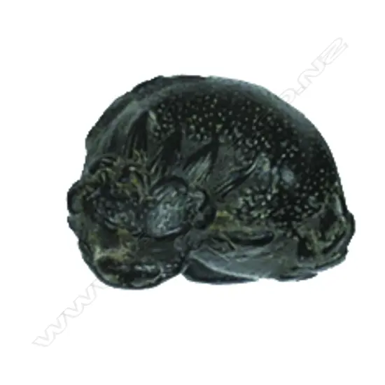 A small compact carved wood netsuke