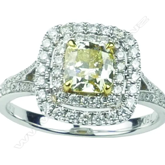 A lady's modern 18ct. white gold fancy yellow diamond cluster ring