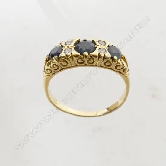 An 18ct. yellow gold sapphire and diamond bridge ring