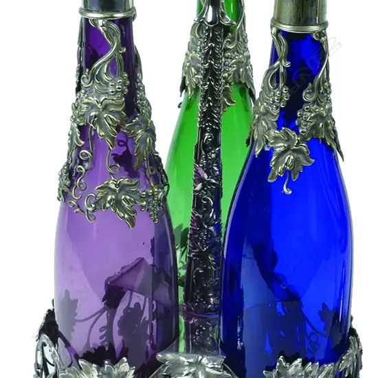 A silver plate and three-bottle decanter stand