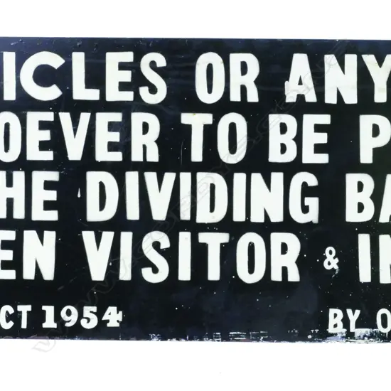 A black and white enamelled sign