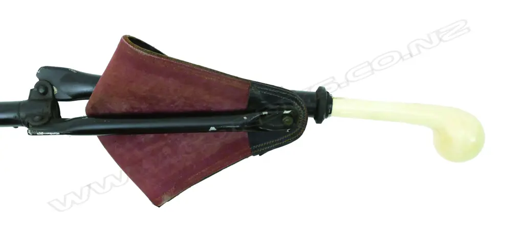 A vintage shooting stick with a metal and leather seat Image 1++