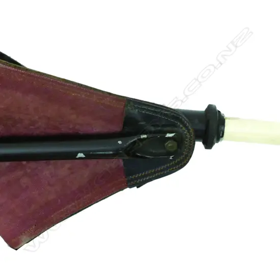 A vintage shooting stick with a metal and leather seat