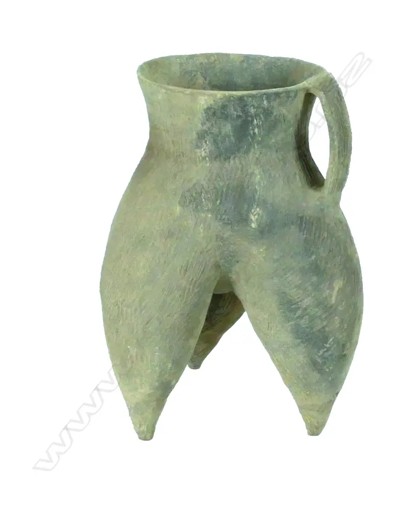A large archaic earthenware vessel udder shaped on a triform base Image 1++