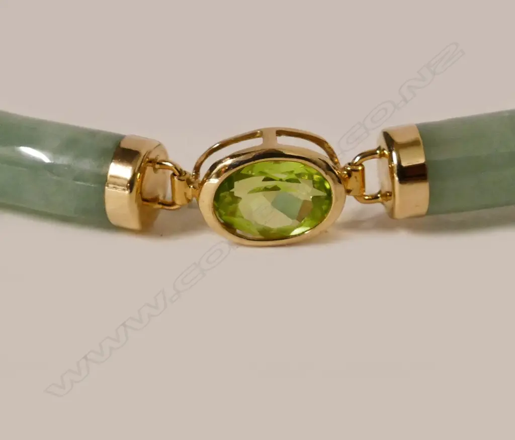 A Chinese green jade green sapphire and 14ct. yellow gold bracelet Image 1++