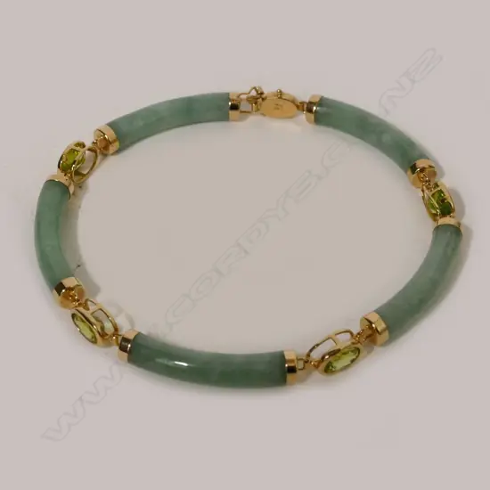A Chinese green jade green sapphire and 14ct. yellow gold bracelet