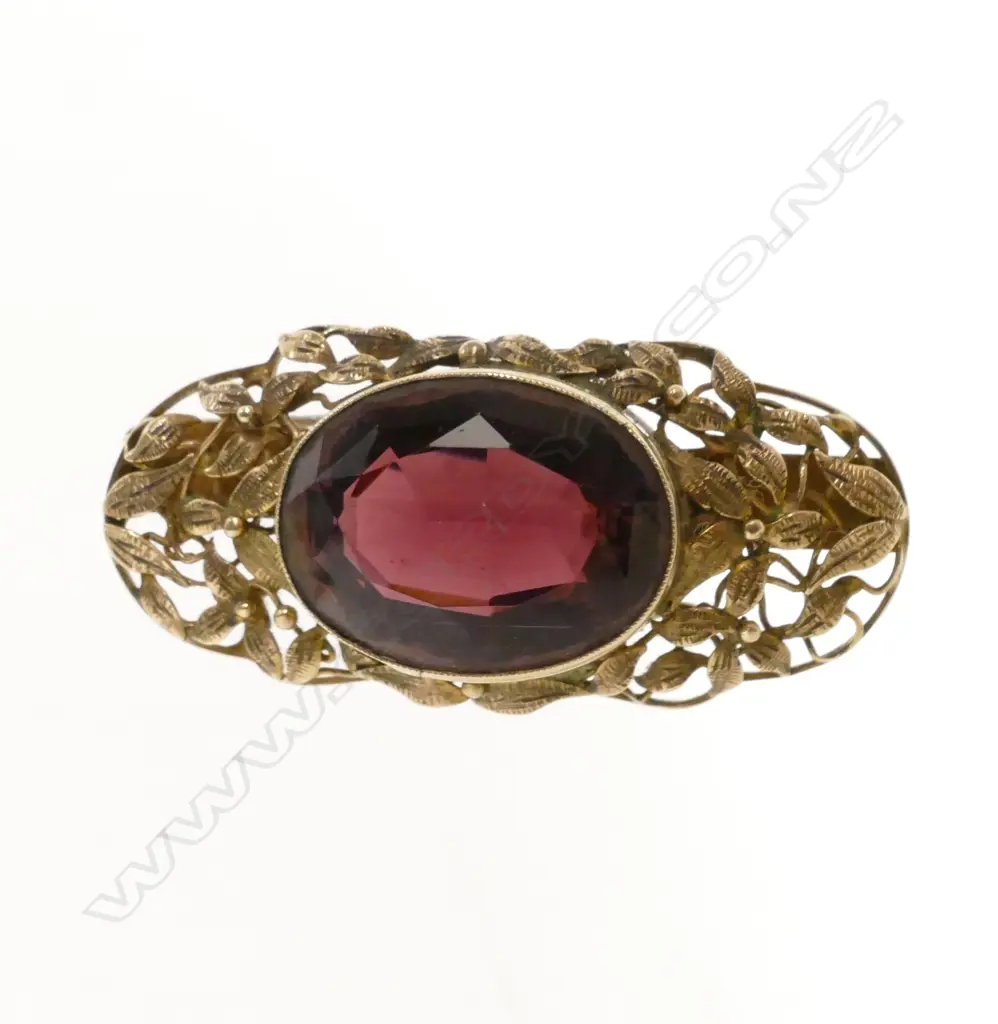 A late 19thC 9ct. yellow gold and purple stone brooch Image 1++