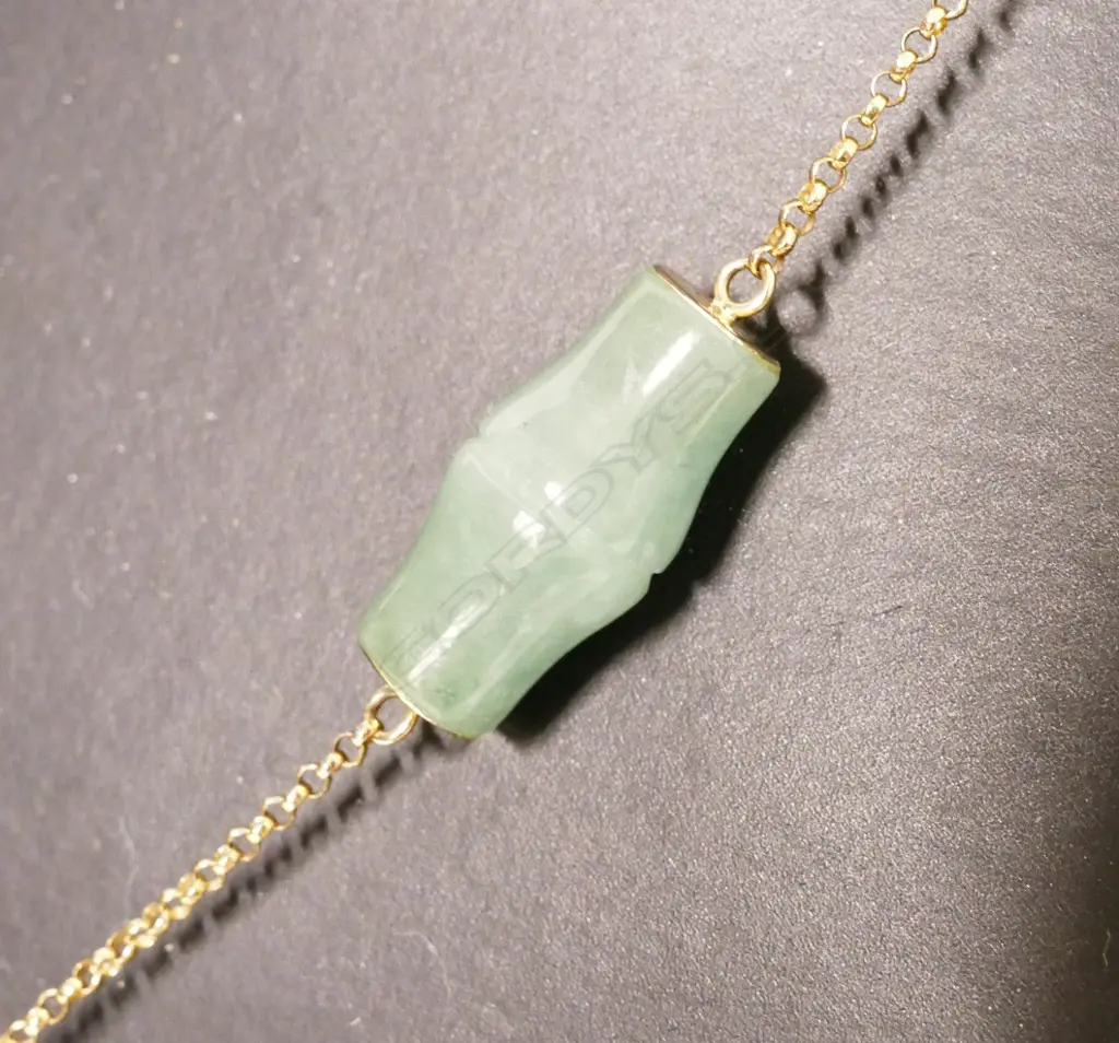 A jade bead and 14ct. yellow gold necklace Image 1++