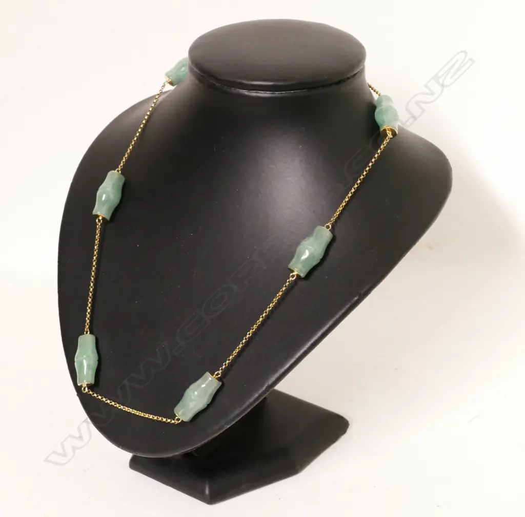 A jade bead and 14ct. yellow gold necklace Image 1++