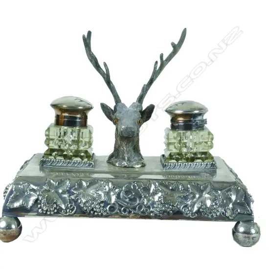 A Victorian silver plated ink stand with two inkwells and a deer's head pen holder