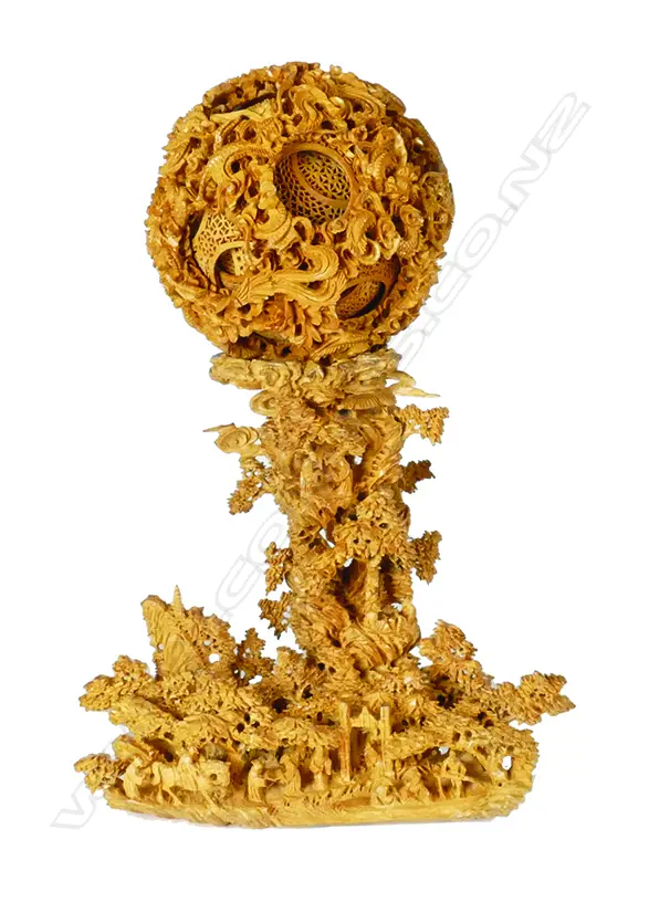 A fine carved boxwood puzzle ball on an intricately carved stand Image 1++