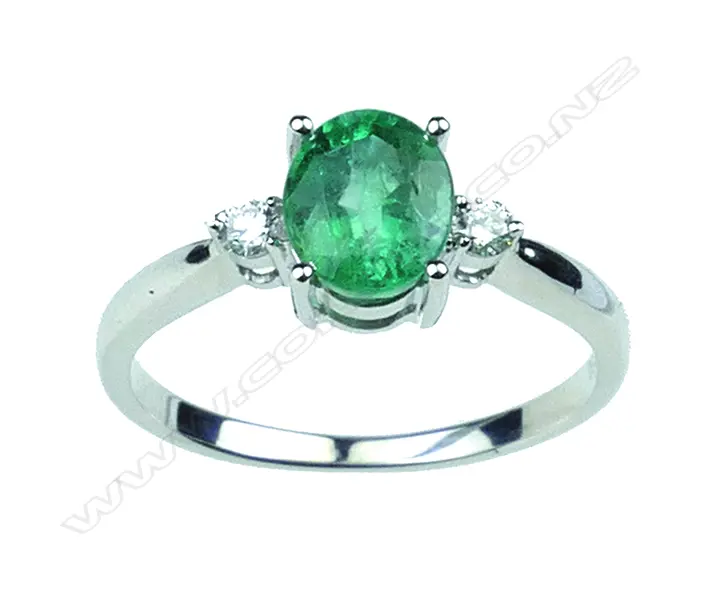 An 18ct. white gold modern emerald and diamond ladies ring Image 1++