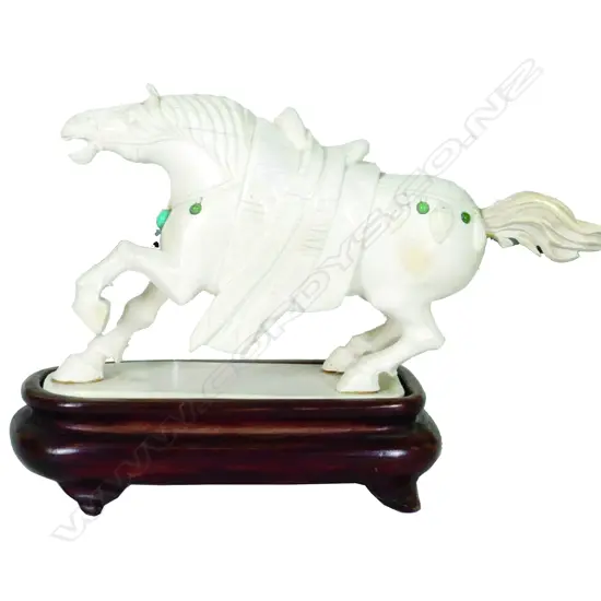 An old Chinese carved ivory horse modelled with one leg raised and in back leaning stance