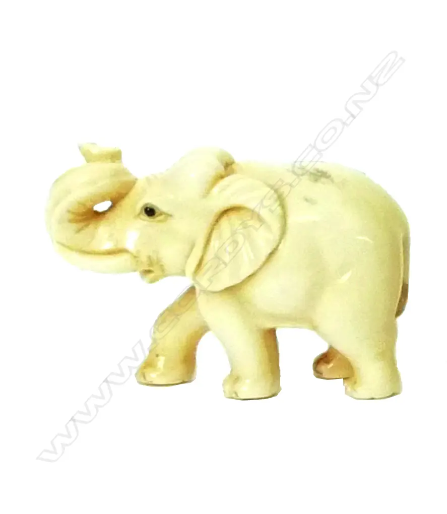 A Japanese ivory netsuke of an elephant with trunk raised Image 1++