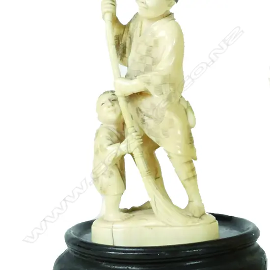A Japanese carved marine ivory figure group