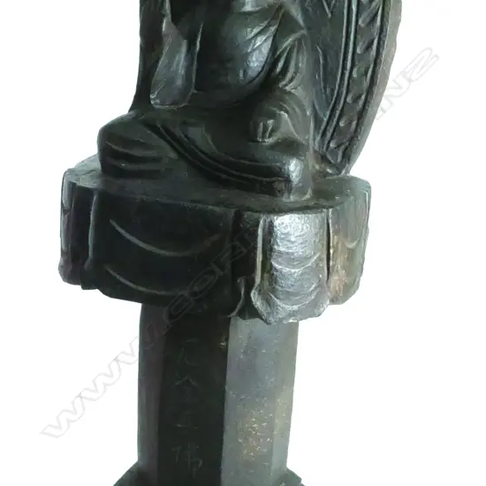 A carved stone Buddha shrine figure