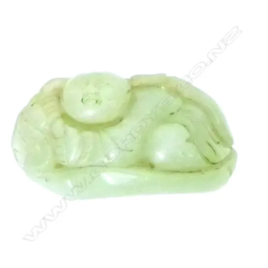 A carved milky pale green jade fingering piece