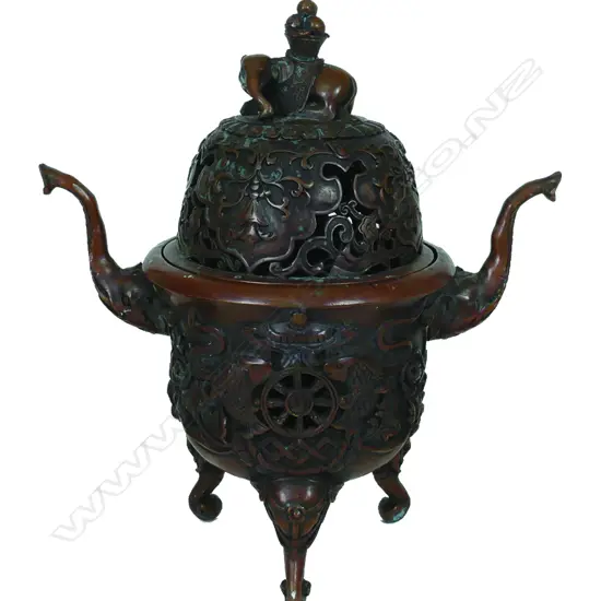 A Chinese copper patinated two-handled tripod incense burner with cover