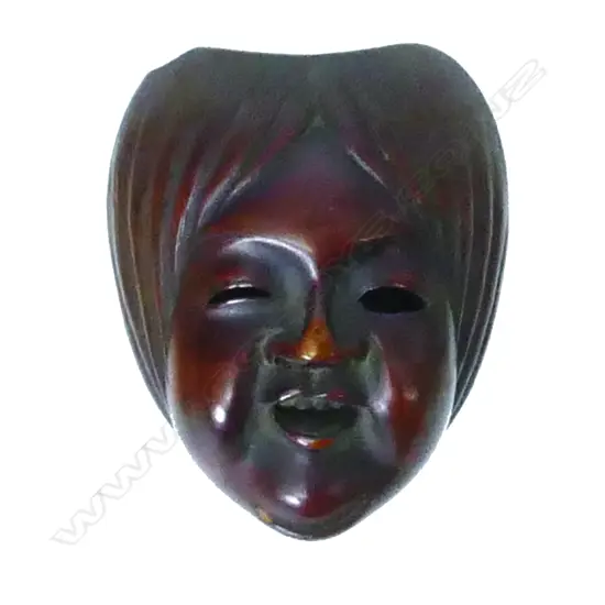 A miniature finely carved wood mask/toggle