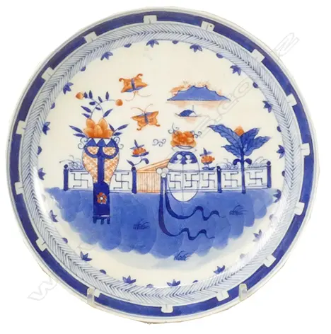 A Chinese porcelain dish painted with a wall garden in underglaze blue and iron-red within a chevron border Image 1++