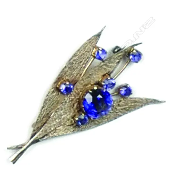 A vintage palladium and yellow gold floral flower and leaf brooch