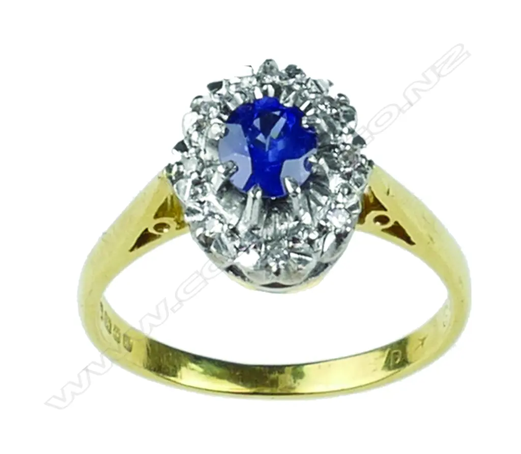 An 18ct. gold sapphire and diamond cluster ring Image 1++