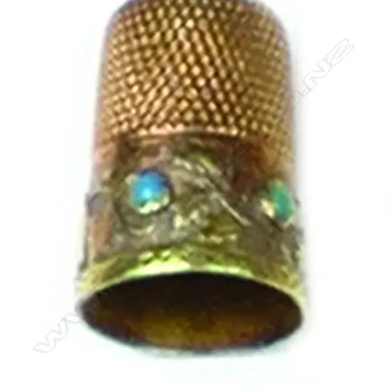An antique 14ct. rose and yellow gold thimble