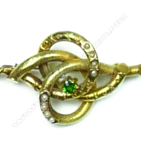 A Victorian 9ct. gilded yellow gold seed pearl and green stone decorative brooch and earring suite