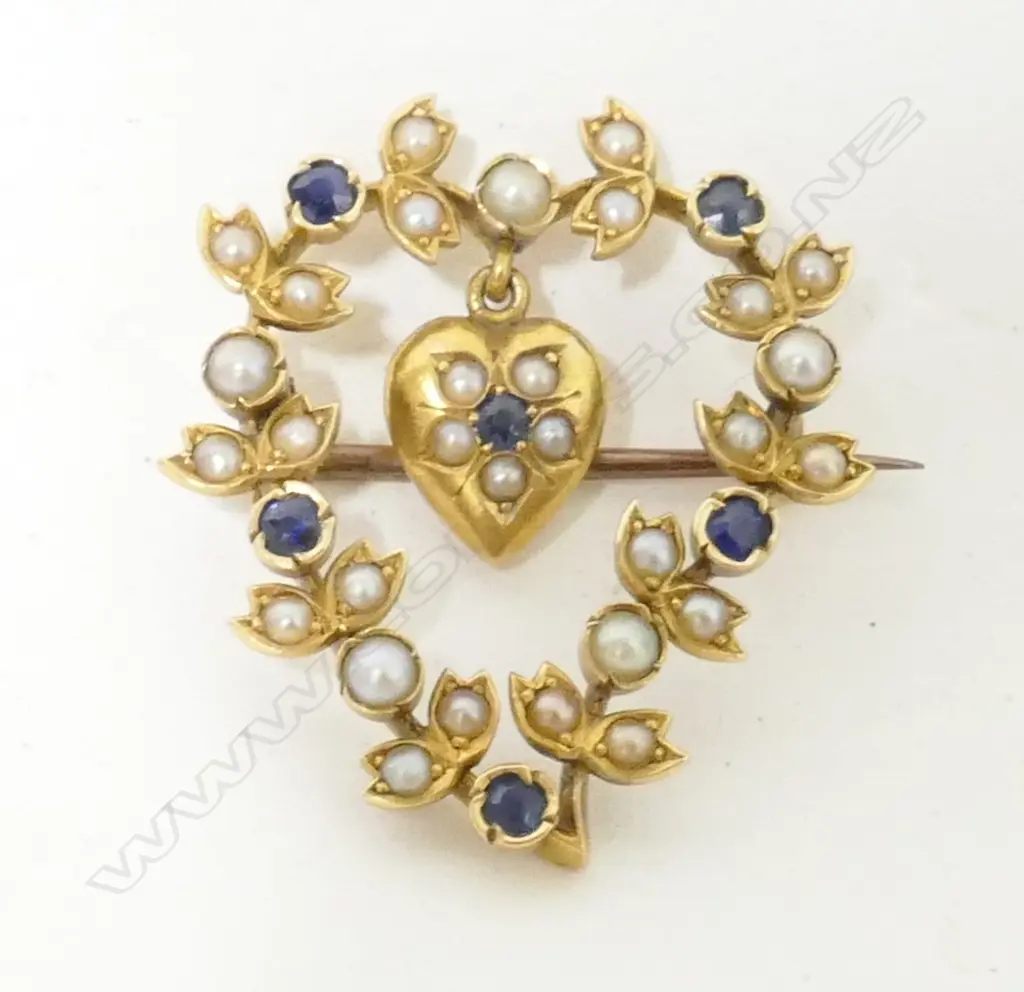 An Edwardian 15ct. yellow gold sapphire and seed pearl open heart brooch Image 1++