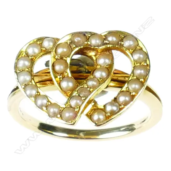 An Edwardian 18ct. yellow and rose gold and seed pearl double heart ring