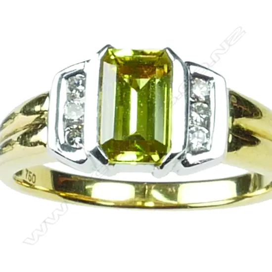 An 18ct. yellow and white gold yellow sapphire and diamond ring