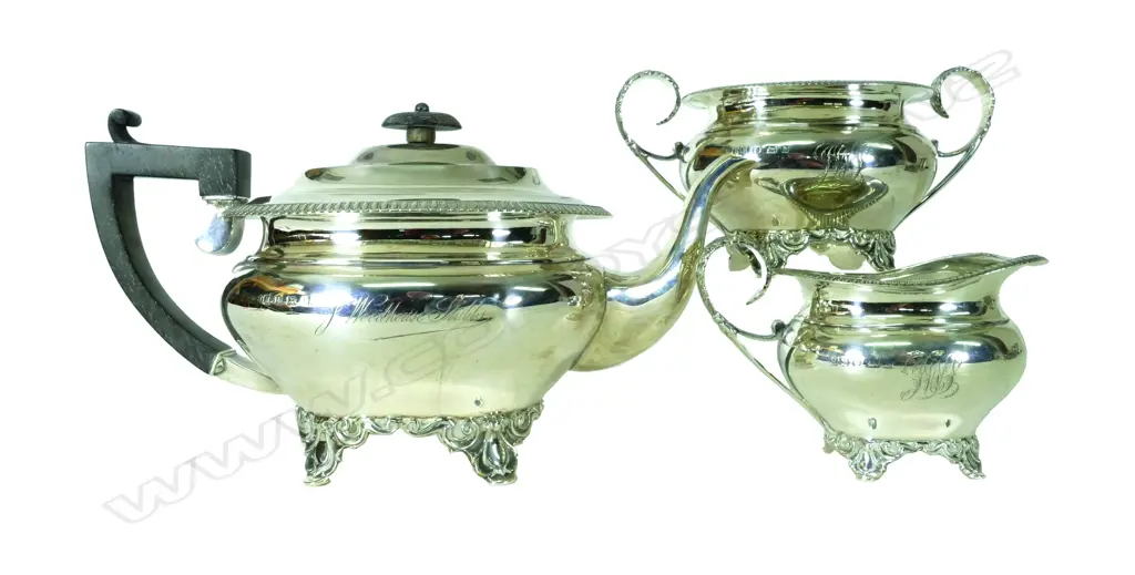 An Edwardian silver three-piece tea set. oval bodies raised on scroll legs Image 1++