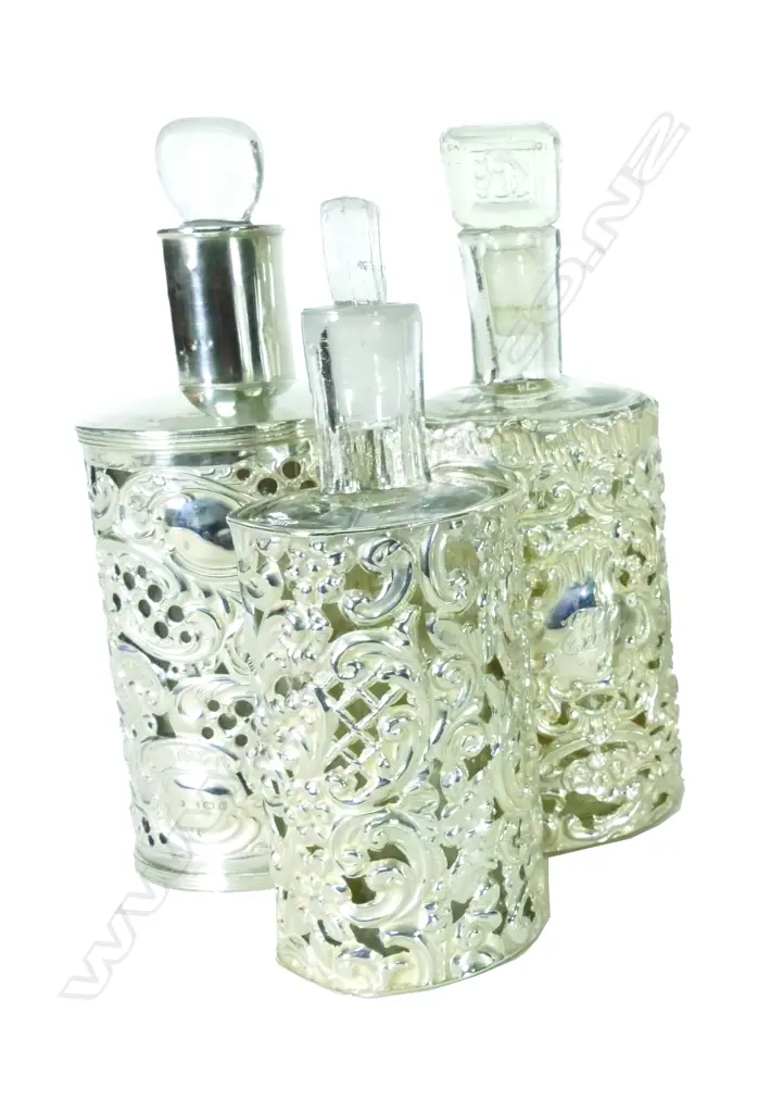 Three late Victorian silver covered glass perfume bottles Image 1++