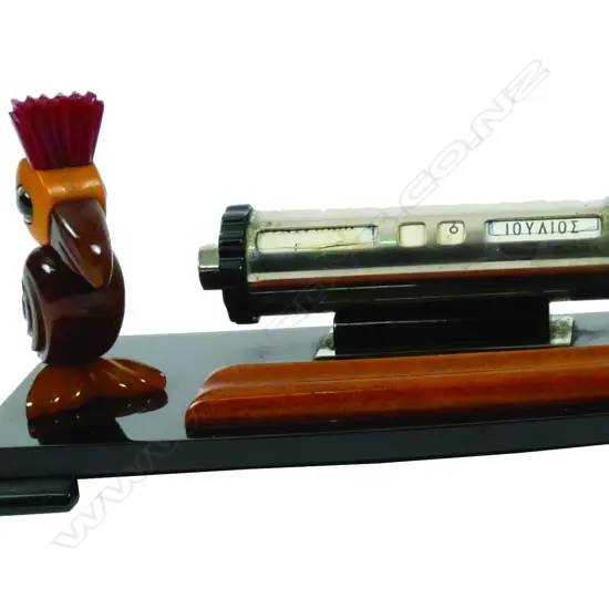 An Art Deco faturan bakelite desk stand the cylinder callender