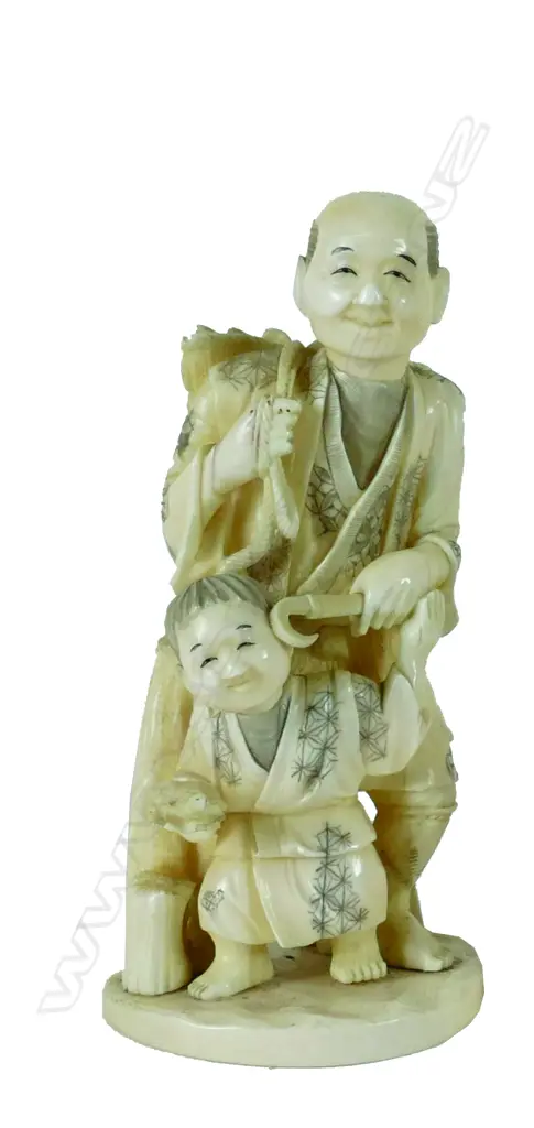 A Japanese marine ivory carving of a peasant gatherer and child.  Their garments engraved with diaper patterns Image 1++